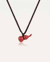 Mini Hulu cinnabar necklace on ivory studio background