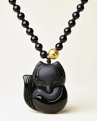 Fox obsidian pendant necklace on ivory studio background
