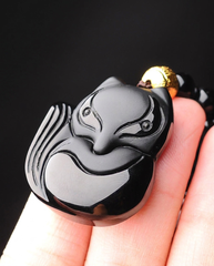 Fox obsidian pendant held in hand