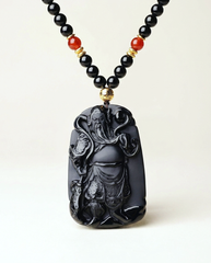 Guan Kong obsidian pendant necklace on ivory studio background
