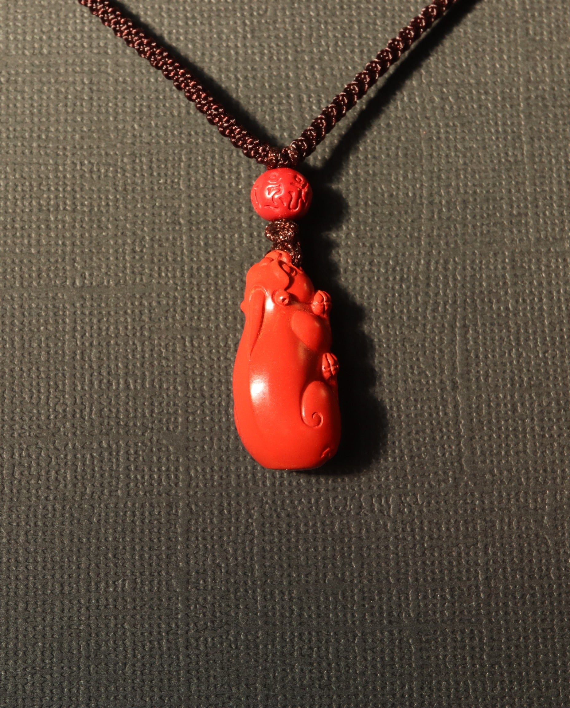 Pixiu cinnabar necklace on dark background