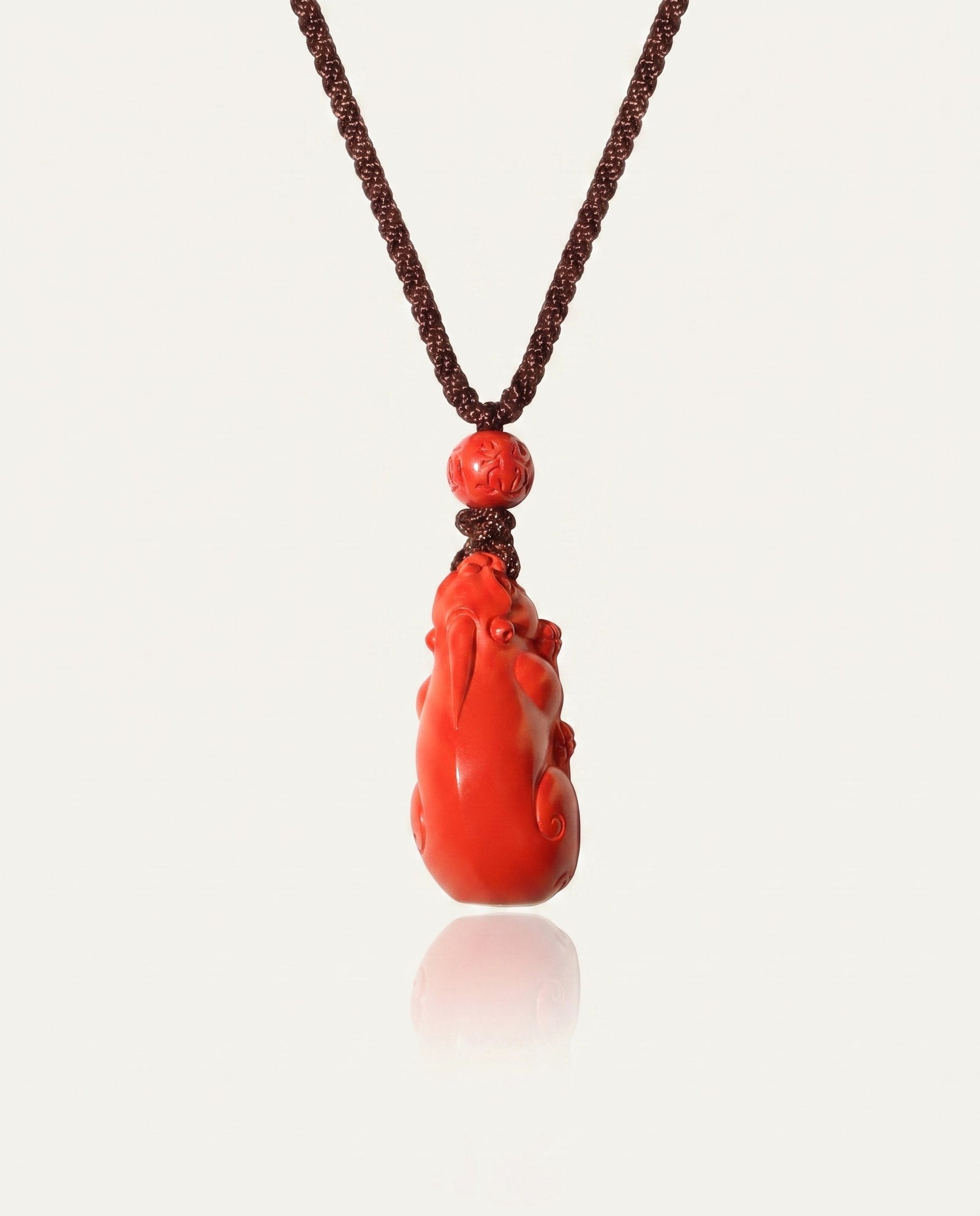 Pixiu cinnabar necklace on ivory studio background