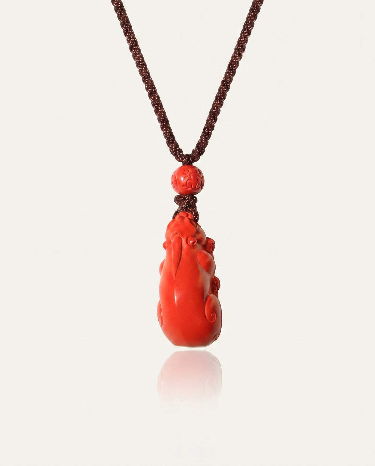 Pixiu cinnabar necklace on ivory studio background