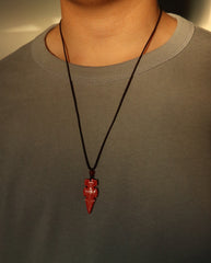 Protection Arrow cinnabar necklace on dark background