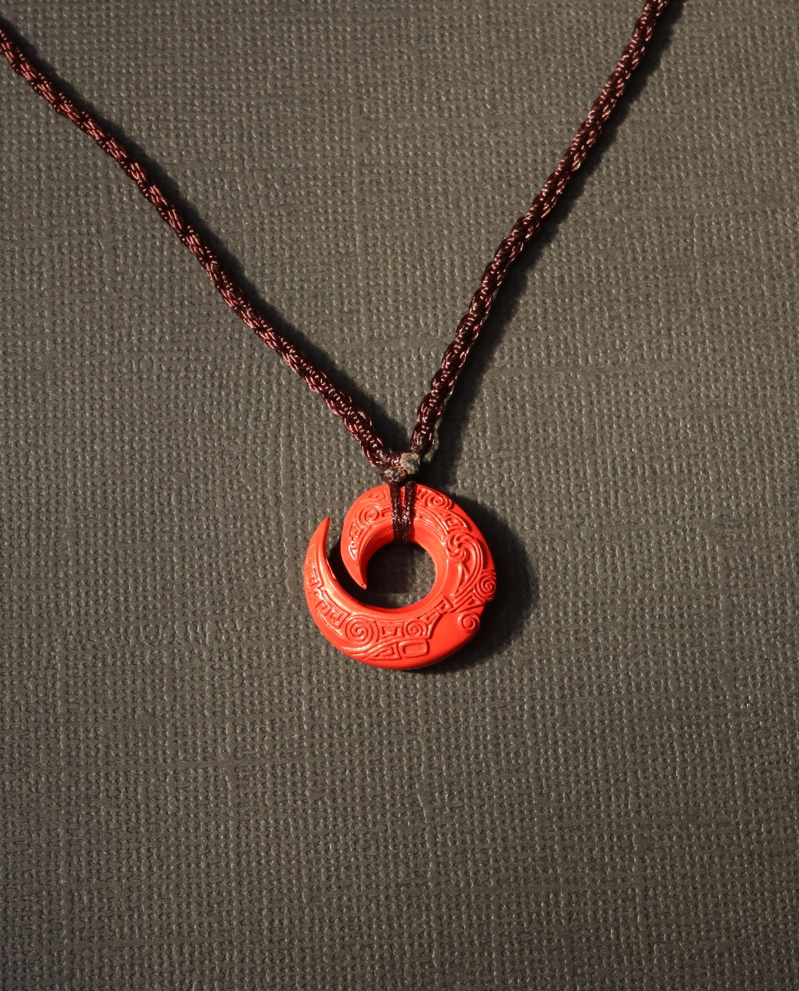 Protection Hook cinnabar necklace on dark background