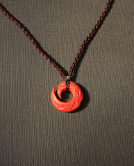 Protection Hook cinnabar necklace on dark background