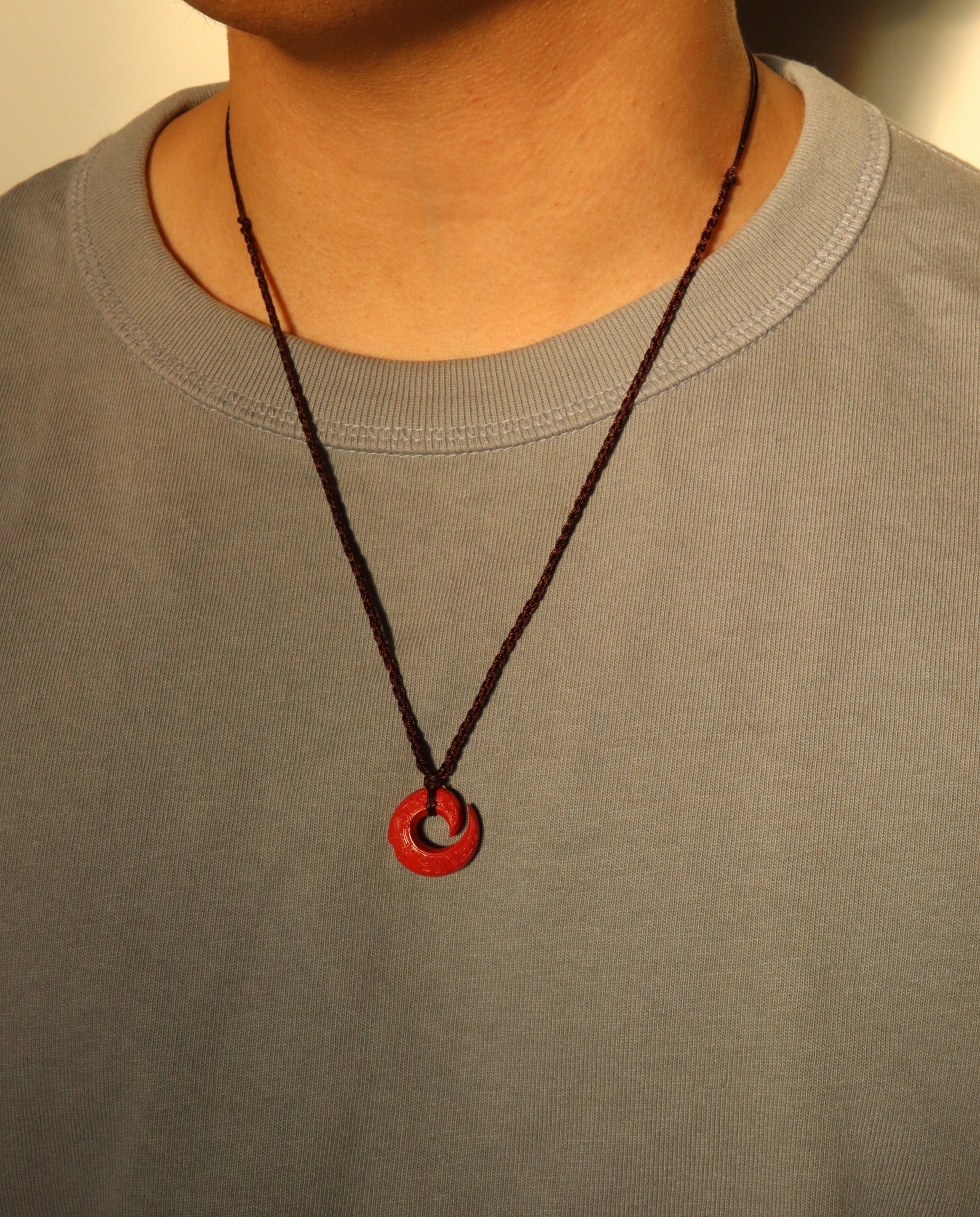 Protection Hook cinnabar necklace on dark background