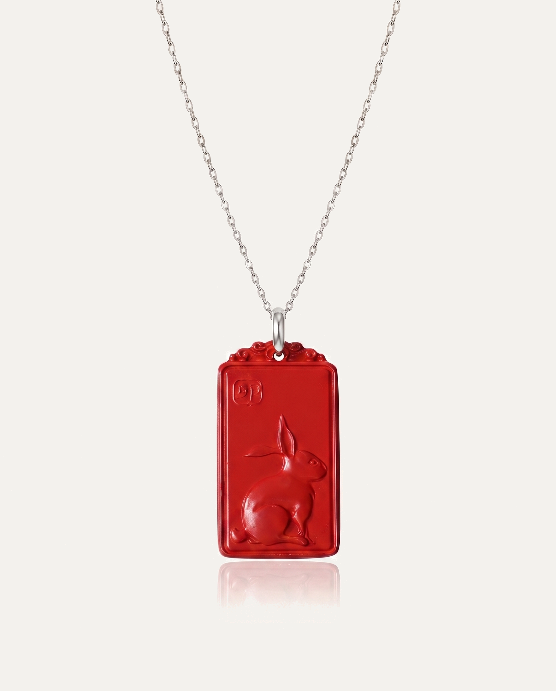 Rabbit Zodiac Cinnabar Pendant on silver chain, ivory background