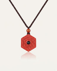 Six Character Mantra Hexagon cinnabar necklace on ivory studio background