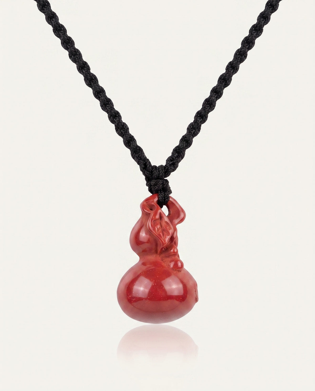 Smooth Hulu cinnabar necklace on ivory studio background