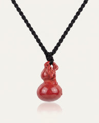 Smooth Hulu cinnabar necklace on ivory studio background