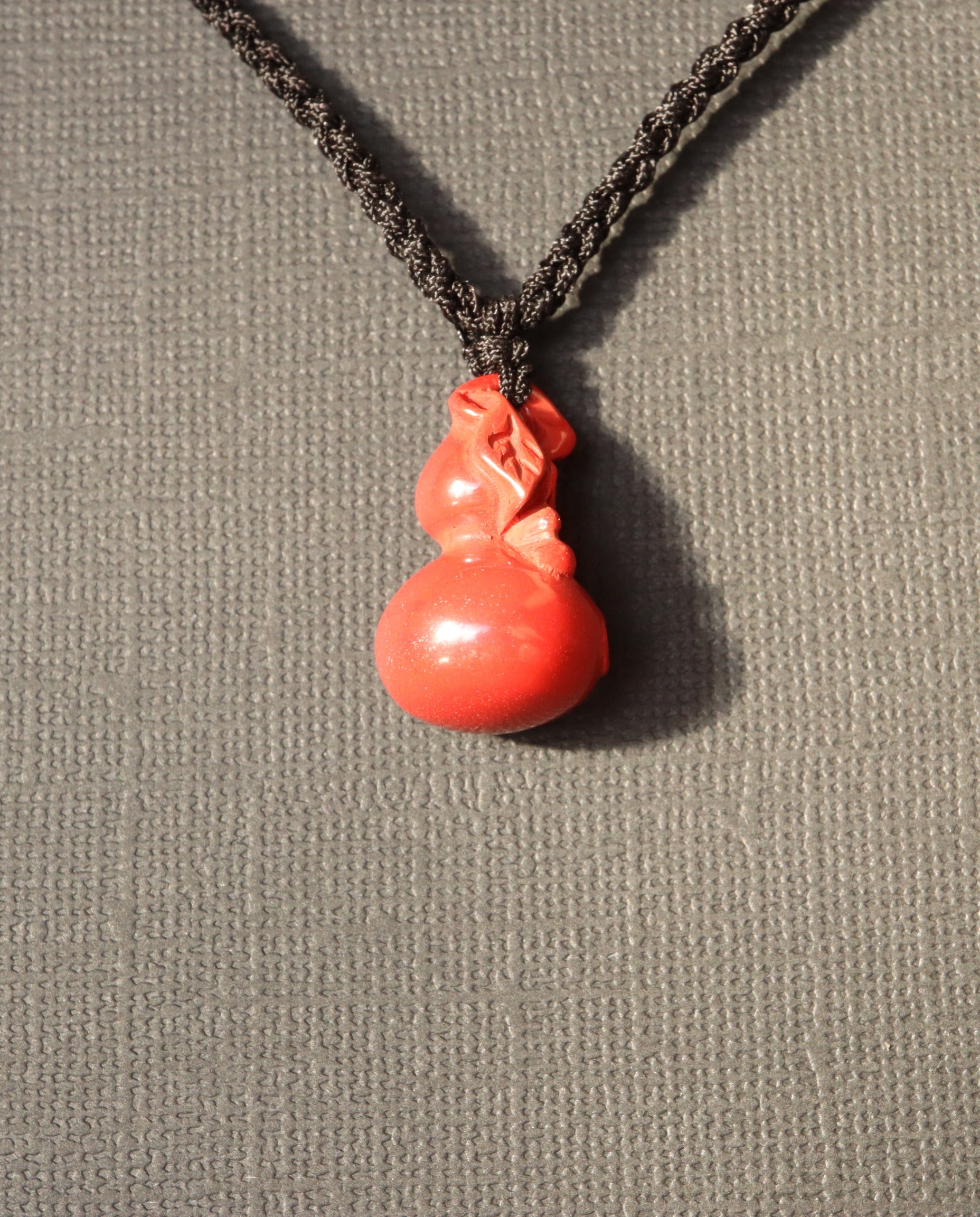 Smooth Hulu cinnabar necklace worn