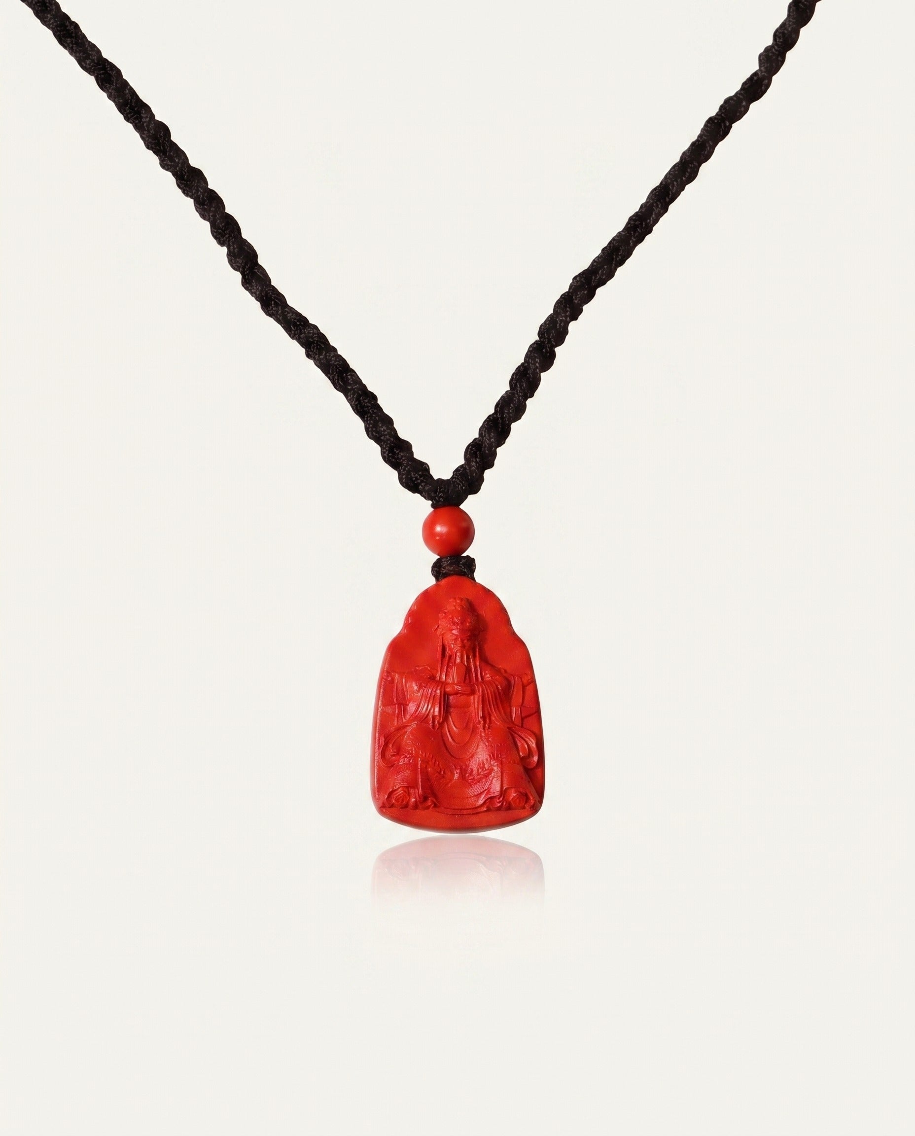Wealth God cinnabar necklace front on ivory studio background