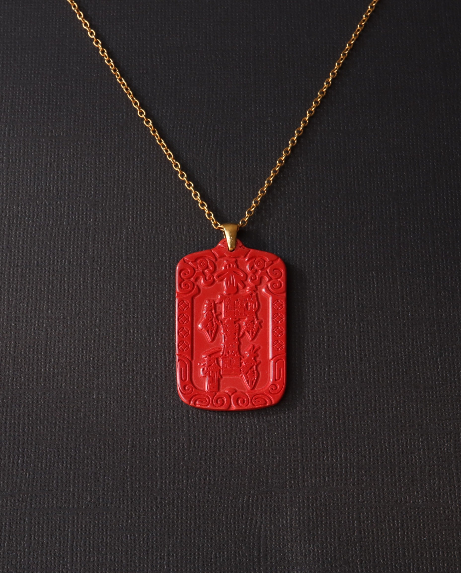 Wealth Talisman cinnabar necklace on dark background