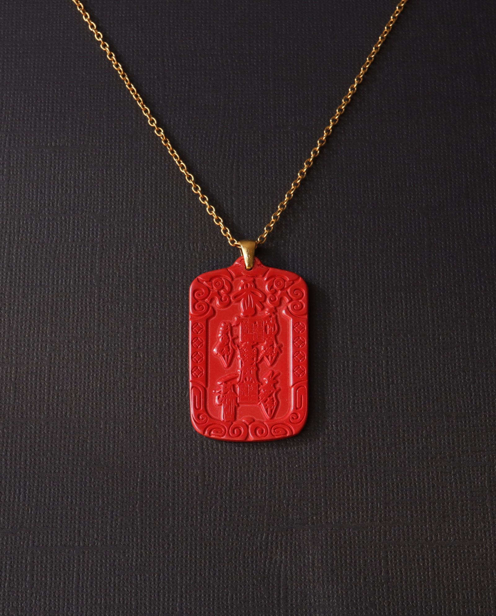 Wealth Talisman cinnabar necklace on dark background