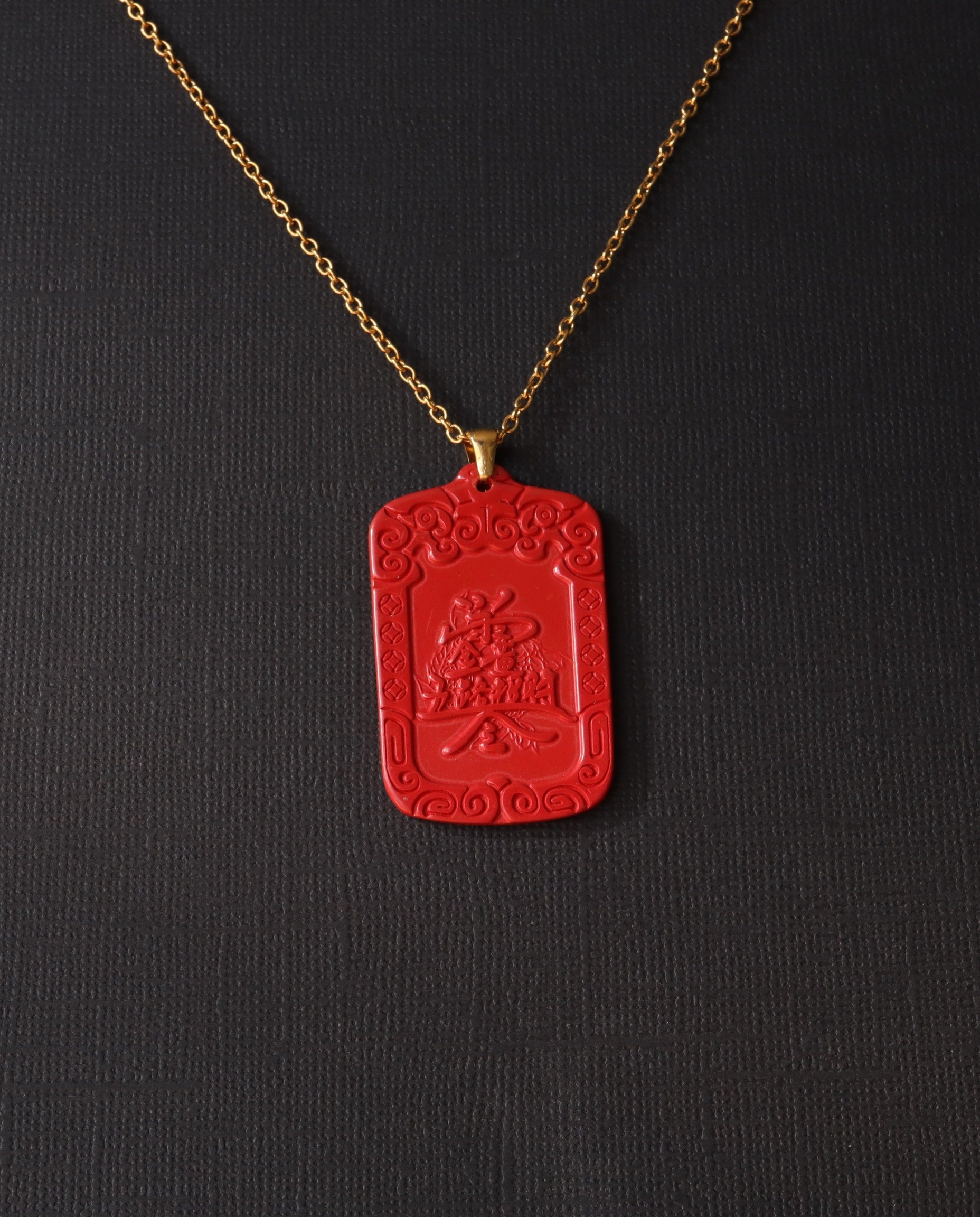 Wealth Talisman cinnabar necklace on dark background