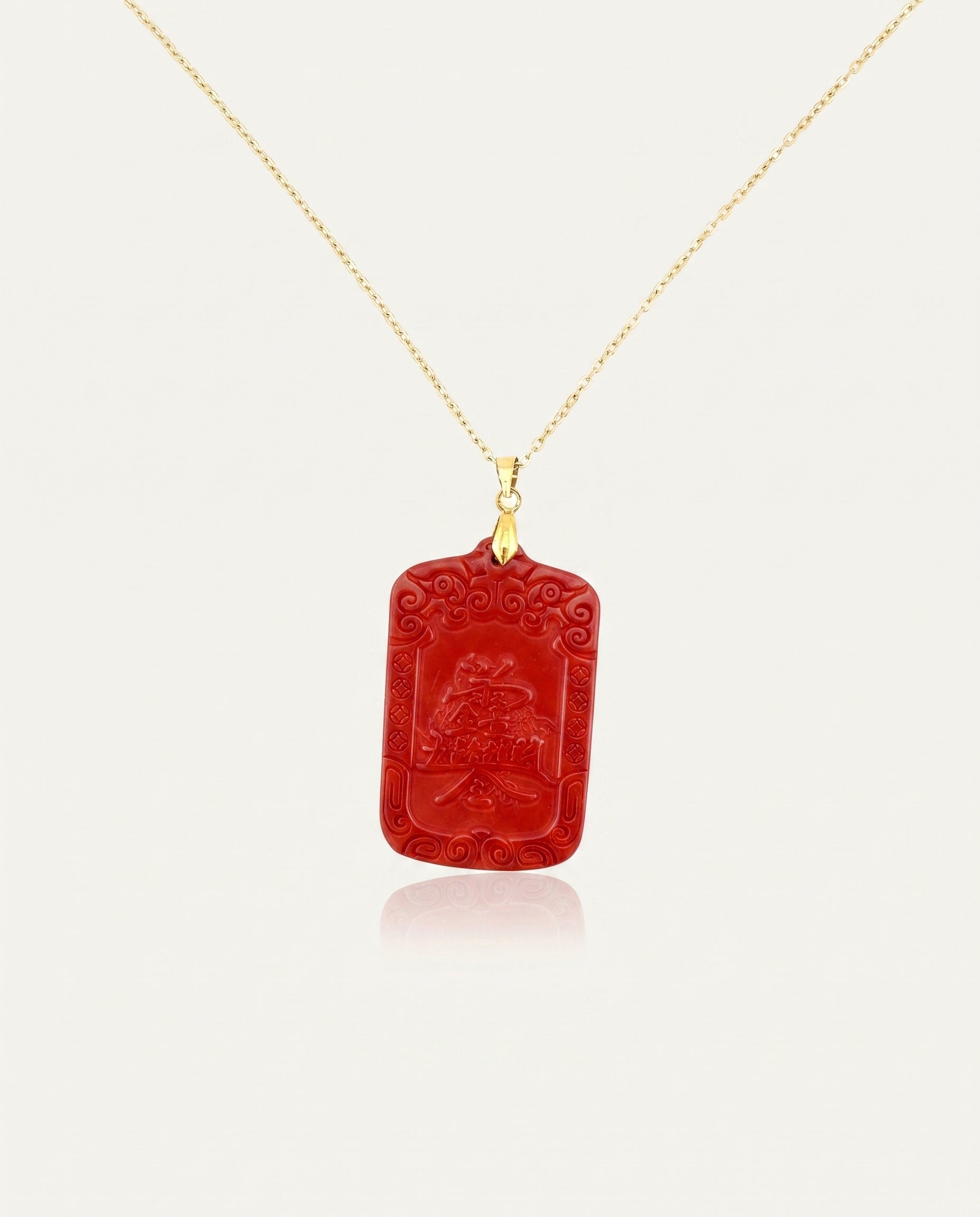 Wealth Talisman cinnabar necklace on gold chain back, ivory studio background