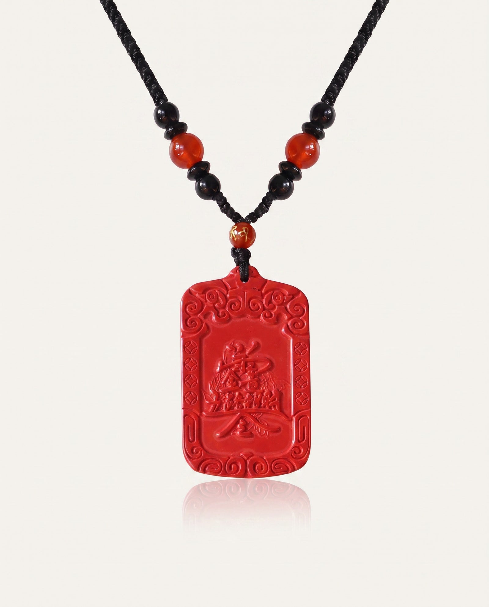 Wealth Talisman cinnabar necklace on ivory studio background