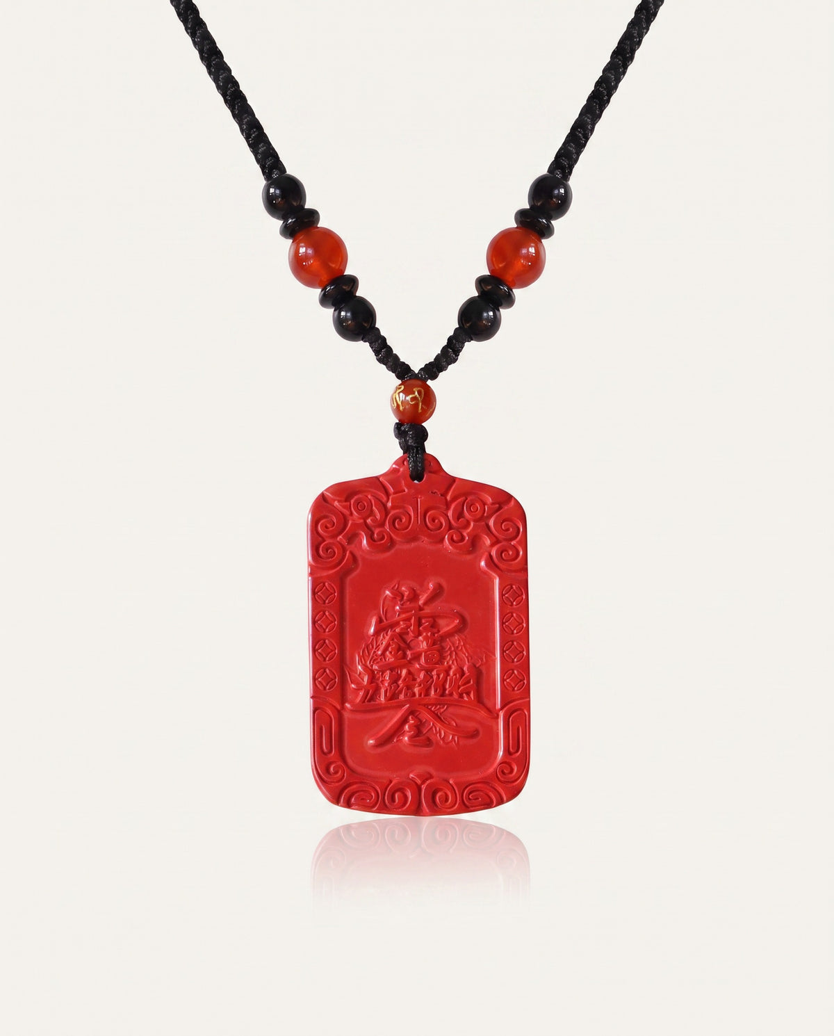 Wealth Talisman cinnabar necklace on ivory studio background