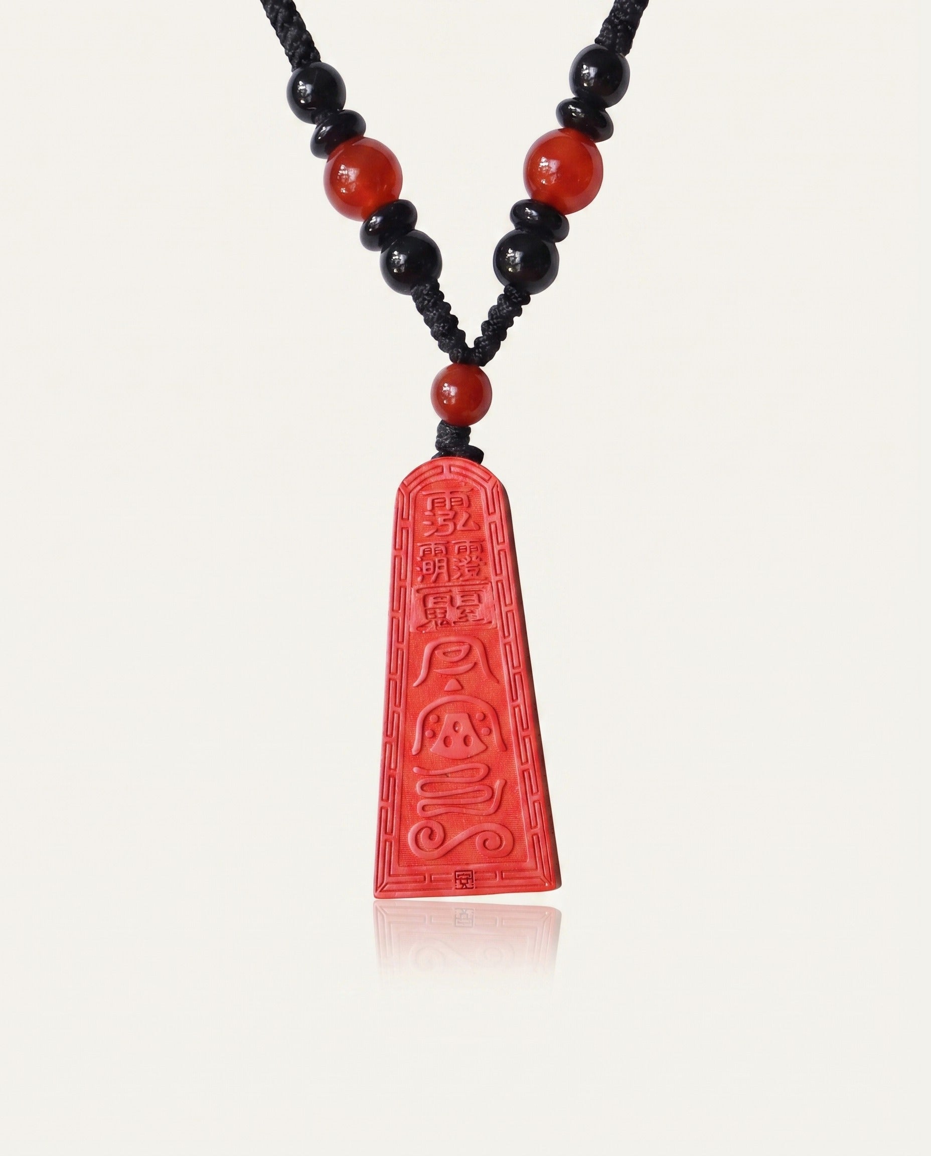 Wealth Talisman Trapezoid cinnabar necklace on ivory studio background
