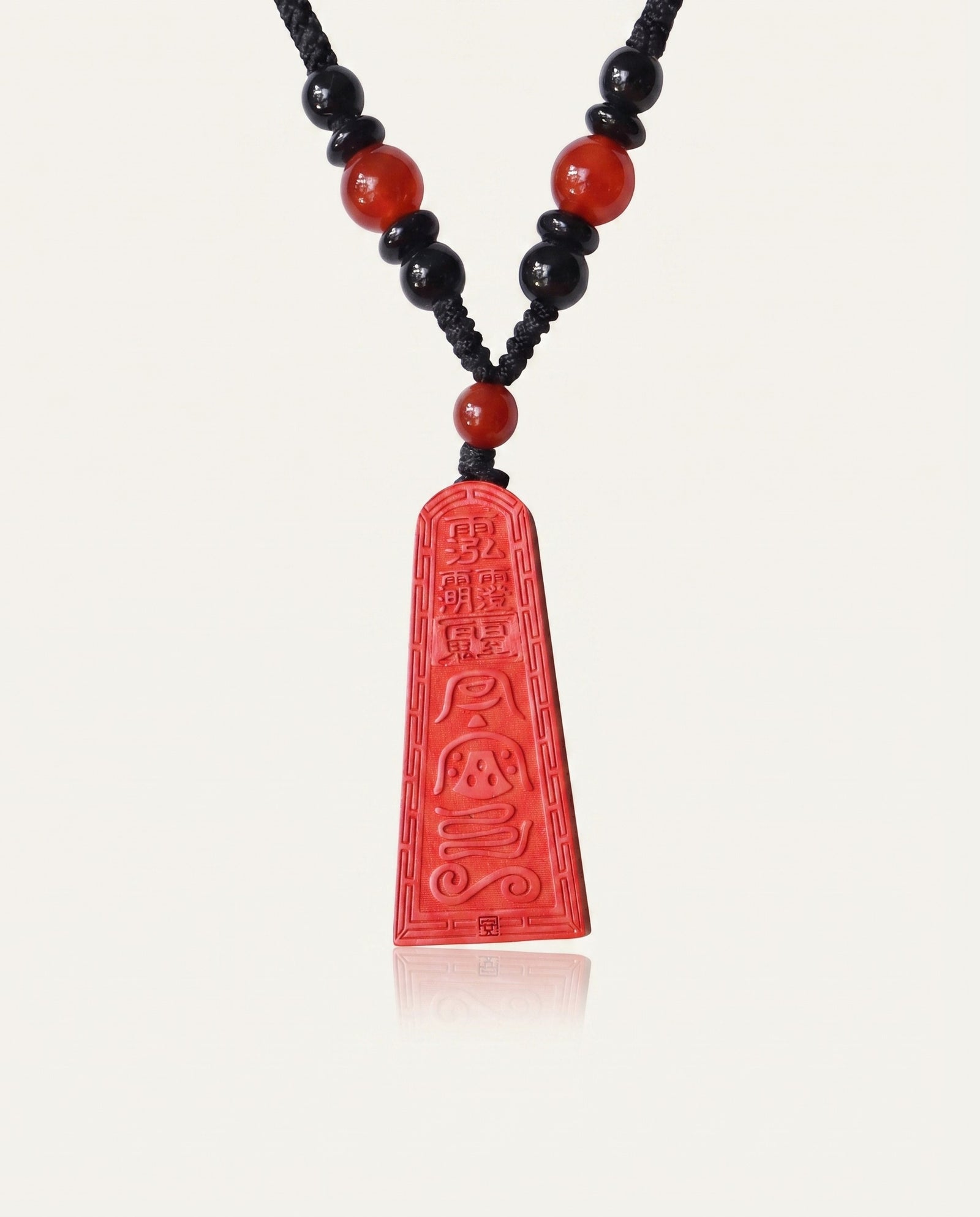Wealth Talisman Trapezoid cinnabar necklace on ivory studio background