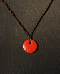Yin Yang cinnabar necklace on dark background