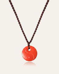 Yin Yang cinnabar necklace on ivory studio background